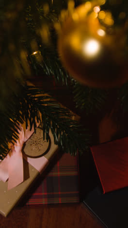 Vertical-Video-Close-Up-Of-Presents-Under-The-Vertical-Video-Of-Tree-At-Home